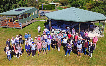 A large group of people by the rotunda next to the Tree Park Kiosk enjoying a function at The Tasmanian Arboretum