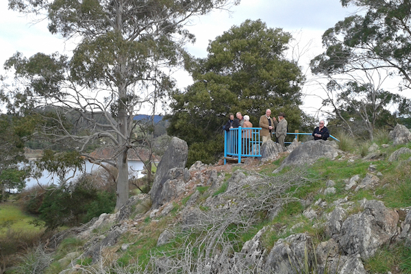 a number of people on the lookout on limestone hill enjoying the scenery below